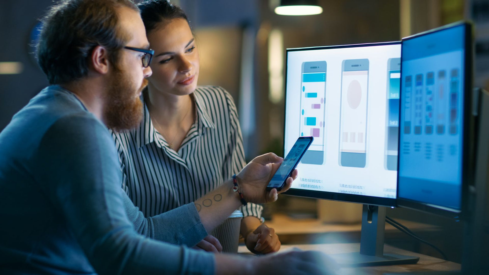 Man and Women looking at app and design